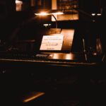 a piano with a note attached to it in a dark room