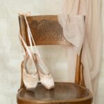 white peep toe heeled shoes on brown wooden round table
